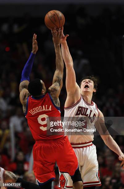 Omer Asik of the Chicago Bulls blocks a shot by Andre Iguodala of the Philadelphia 76ers in Game Five of the Eastern Conference Quarterfinals during...