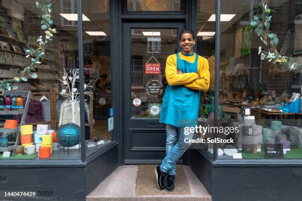 male business owner standing in front of store - support local stock pictures, royalty-free photos & images