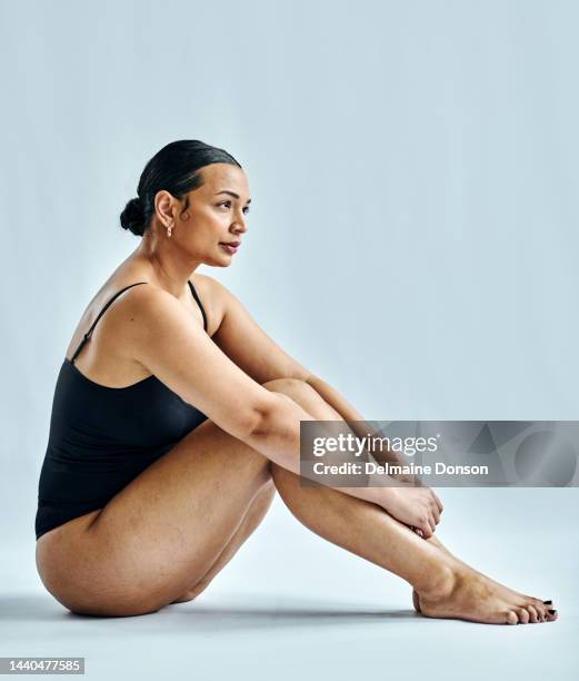 body positive, woman in bikini and with confidence, pride and skincare with blue studio background. female health, natural beauty and happiness to celebrate curvy body and healthy skin in swimwear - voluptuoso imagens e fotografias de stock