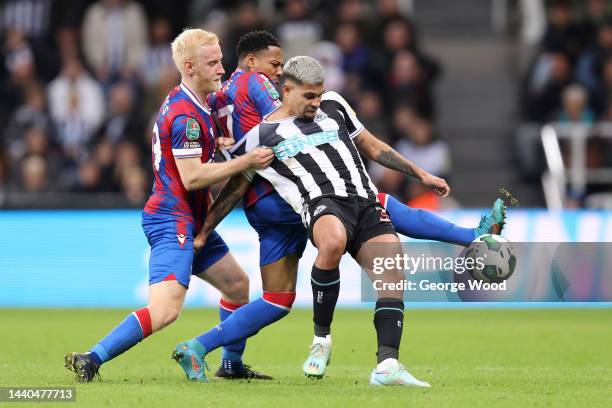 Bruno Guimaraes of Newcastle United is challenged by Will Hughes and Nathaniel Clyne of Crystal Palace during the Carabao Cup Third Round match...