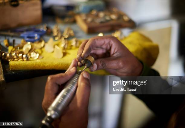 man, hands and jewelry drill for ring in manufacturing workshop, small business or accessory production factory. zoom, jewellery designer or metal shaping tools for filing fashion or luxury gold gift - jewelry making stock pictures, royalty-free photos & images