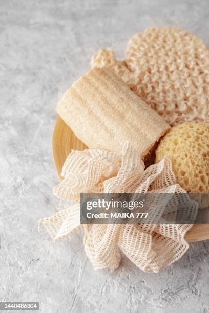 collection of assorted eco-friendly bathroom tools on gray concrete background. set of zero waste cleaning products. eco friendly concept. - loofah stock-fotos und bilder