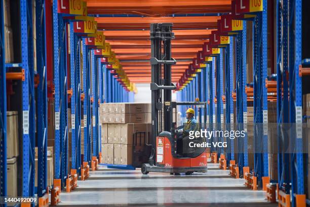 An employee transfers parcels at a logistic base of e-commerce giant Suning one day before China's Double 11 Shopping Festival on November 10, 2022...