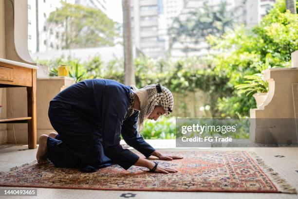 young muslim man praying - namaz stock pictures, royalty-free photos & images