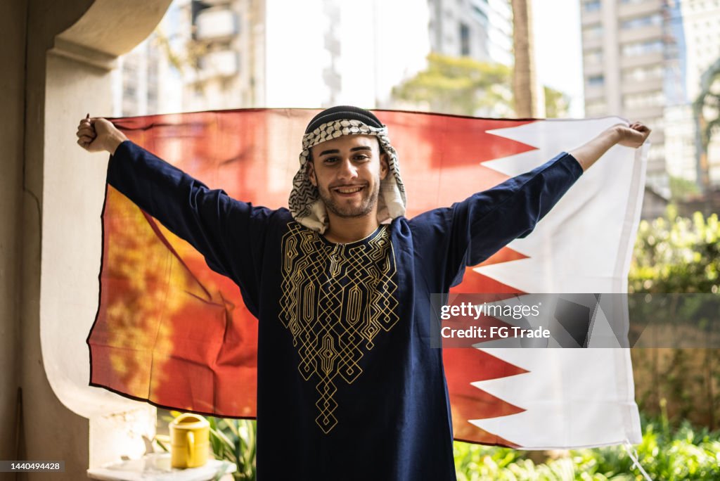 Portrait of a young man with Qatari flag