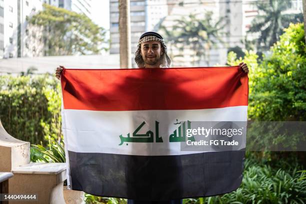 portrait of a young man with iraq flag - iraq flag stock pictures, royalty-free photos & images