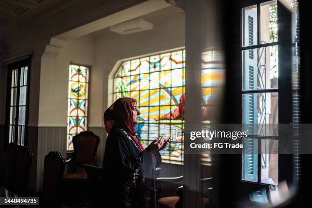 mature islamic woman praying at home - namaz stock pictures, royalty-free photos & images