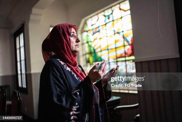 mature islamic woman praying at home - namaz stock pictures, royalty-free photos & images