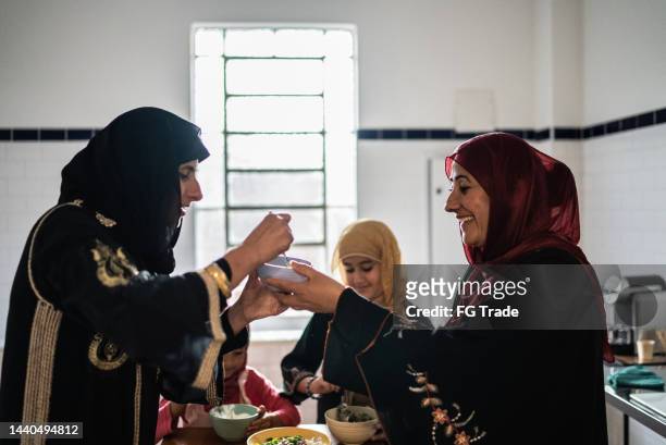 islamic women preparing food at home - smelling food stock pictures, royalty-free photos & images