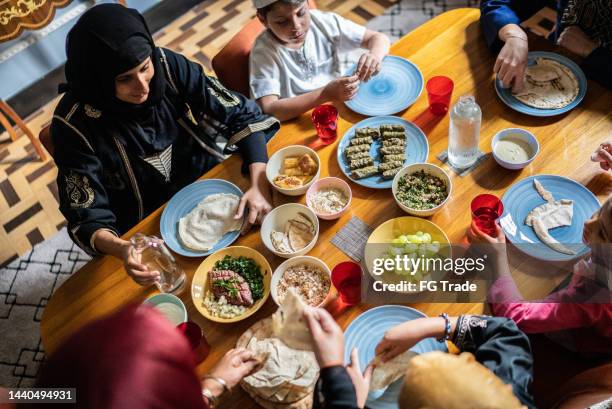 high angle view of a islamic family having lunch together at home - lebanese food stockfoto's en -beelden