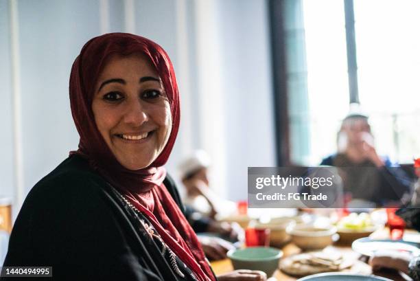 portrait of a mature woman having lunch with family at home - lebanon concept stockfoto's en -beelden