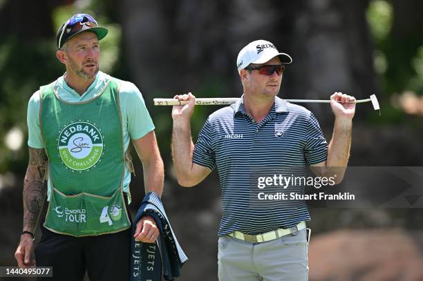 Tommy Fleetwood's caddie Ian Finnis and Ryan Fox of New Zealand chat on the ninth hole during Day One of the Nedbank Golf Challenge at Gary Player CC...