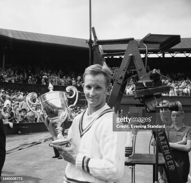Australian tennis player Rod Laver proudly holding the men's singles trophy after defeating Chuck McKinley at the Wimbledon Championships in London...