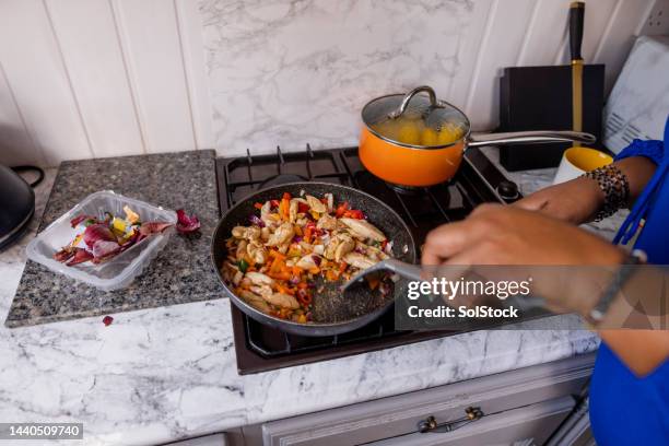 cooking on gas - stir frying european stock pictures, royalty-free photos & images