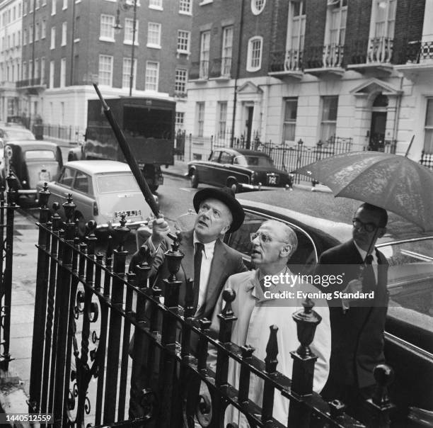 Photographer and costume designer Cecil Beaton and director George Cukor researching locations for their film 'My Fair Lady' in London on September...