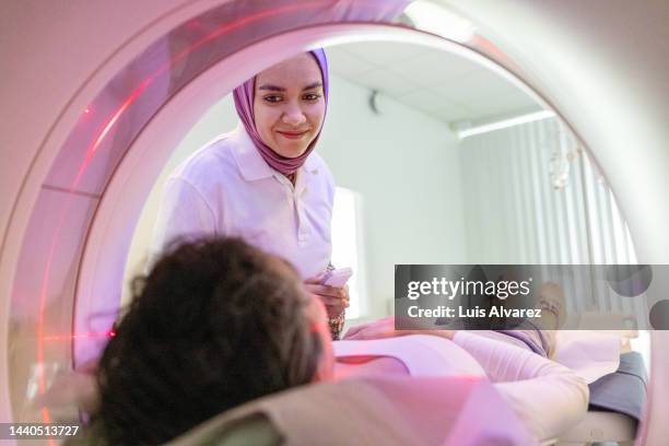 doctors and woman patient during mri scan - science religion stock pictures, royalty-free photos & images