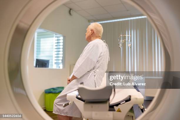 senior patient at clinic for mri scan - cancer research stock pictures, royalty-free photos & images