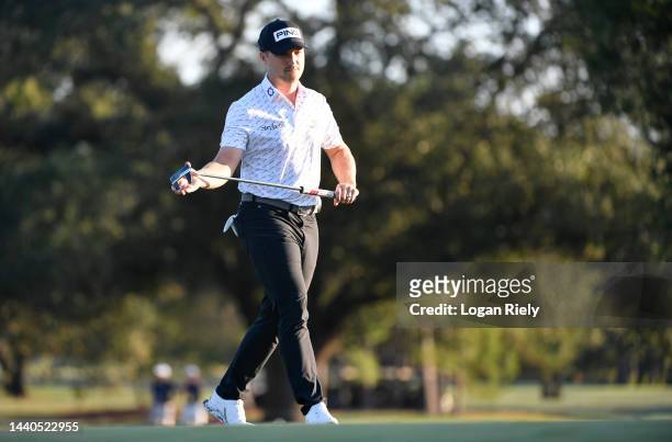 Austin Cook of the United States walks on the 13th green during the first round of the Cadence Bank Houston Open at Memorial Park Golf Course on...