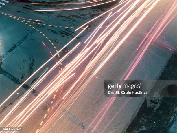 night high angle aerial view of high street city downtown traffic light trails in ho chi minh city, vietnam - car red light stock pictures, royalty-free photos & images
