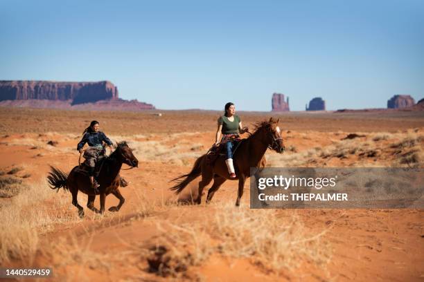 horse riding in the navajo desert - horseback riding arizona stock pictures, royalty-free photos & images