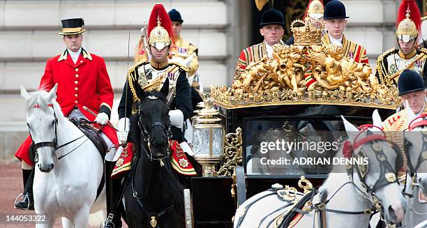 Britain's Queen Elizabeth II sat next to Prince Philip, Duke of Edinburgh, rides in the Australian State Coach flanked by guards and footmen as she...