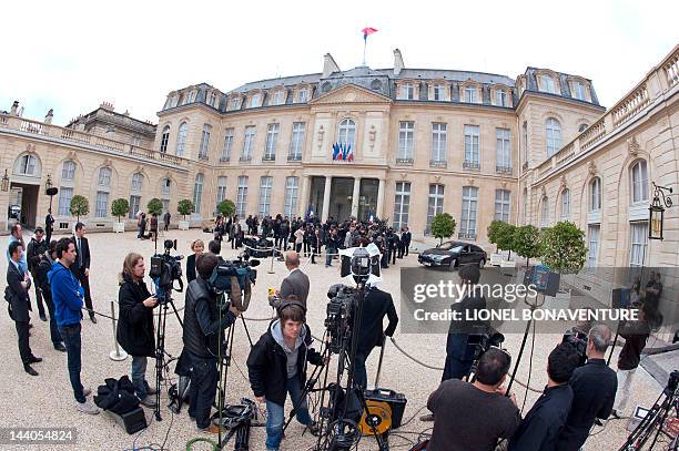 Journalists wait as France's ministers leaving the Elysee presidential palace, on May 9, 2012 in Paris, at the end of the last weekly cabinet meeting...