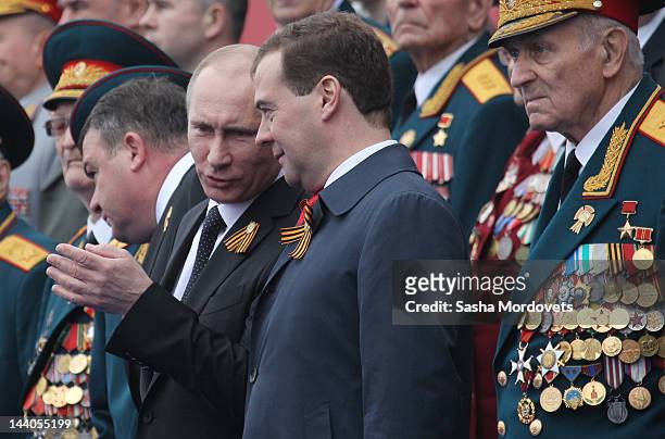 President Vladimir Putin speaks to Prime Minister Dmitry Medvedev during the Victory Day Parade at Red Square on May 9, 2012 in Moscow, Russia. Over...