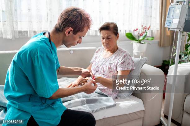 health visitor and a woman during home - iv bag stock pictures, royalty-free photos & images