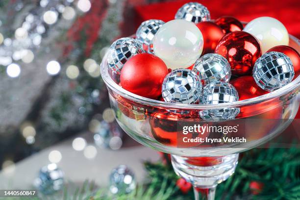 xmas present, gift, congratulation, new year party invitation.  winter holidays and black friday concept with disco balls in cocktail glass. - silver dress imagens e fotografias de stock