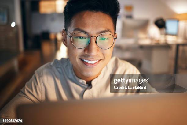 laptop, information technology and business man in night office for web design, software development or it code analysis. asian man glasses with screen reflection working at an online global company - webdesigner stockfoto's en -beelden