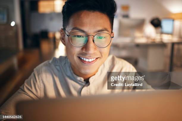 Laptop, information technology and business man in night office for web design, software development or IT code analysis. Asian man glasses with screen reflection working at an online global company
