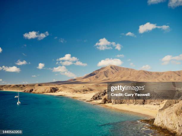 elevated view over coastline at playa papagayo, lanzarote - lanzarote fotografías e imágenes de stock