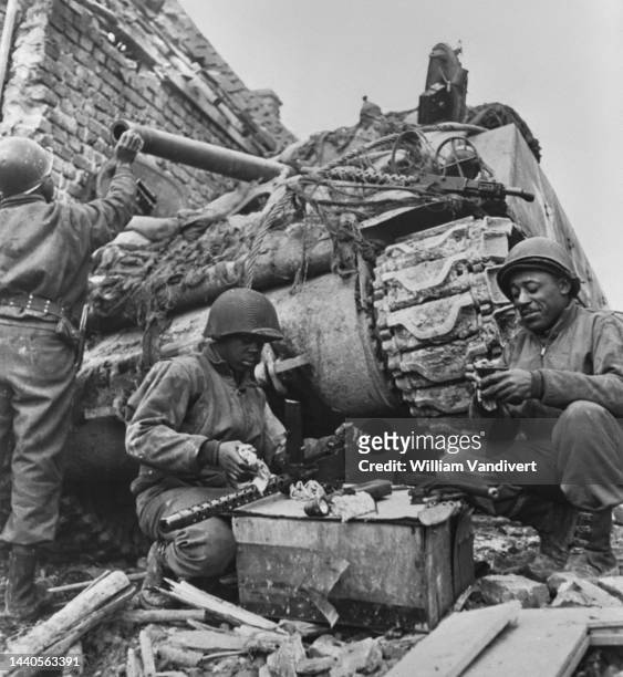 An African American tank crew from the 784th Tank Battalion attached to the 35th Infantry Division of the United States Ninth Army undertake cleaning...