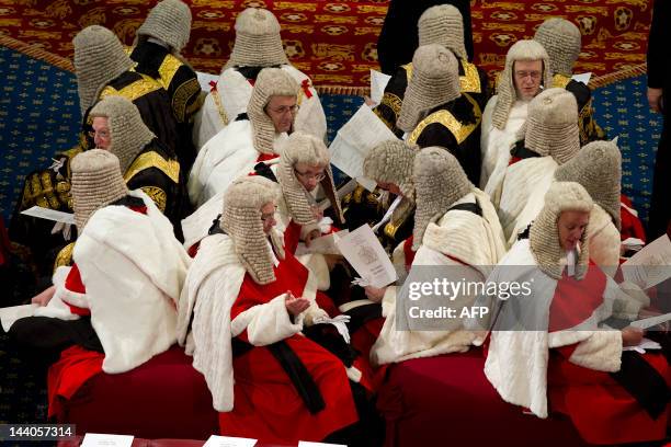 The judicial Law Lords in their traditional ceremonial robes sit as they wait for Britain's Queen Elizabeth II to read the Queen's Speech in the...