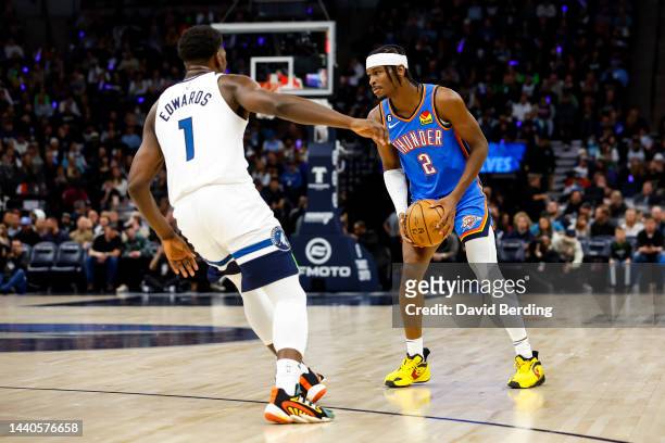Shai Gilgeous-Alexander of the Oklahoma City Thunder competes while Anthony Edwards of the Minnesota Timberwolves defends in the first quarter of the...