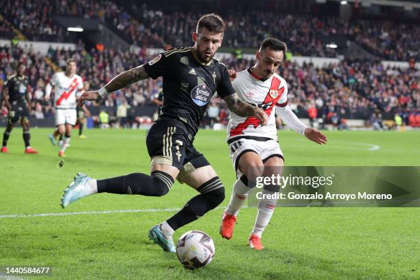 Carles Perez of RC Celta de Vigo competes for the ball with Alvaro Garcia of Rayo Vallecano de Madrid during the LaLiga Santander match between Rayo...