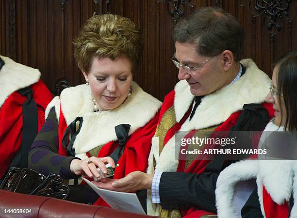 Members of the House of Lords eat tictacs as they wait to hear Britain's Queen Elizabeth II read the Queen's Speech in the Chamber of the House of...