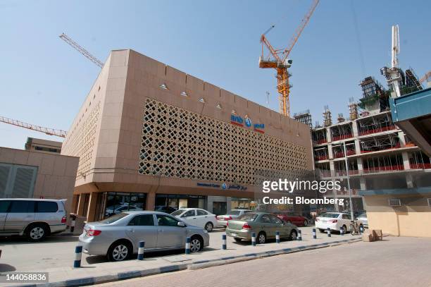 Construction cranes operate on new buildings near the offices of ANB Invest, or Arab National Investment Company, in Riyadh, Saudi Arabia, on...