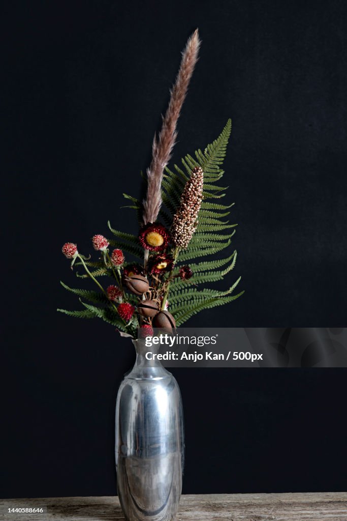 Beautiful red dried flower arrangement in a metal vase