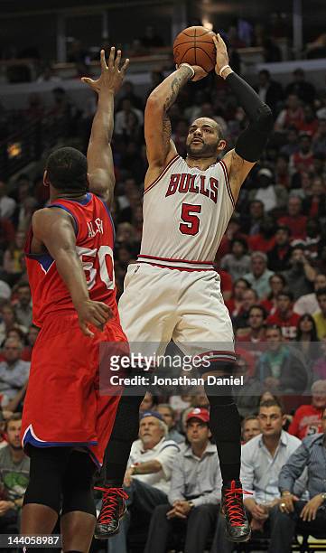 Carlos Boozer of the Chicago Bulls shoots over Lavoy Allen of the Philadelphia 76ers on his way to 19 points in Game Five of the Eastern Conference...