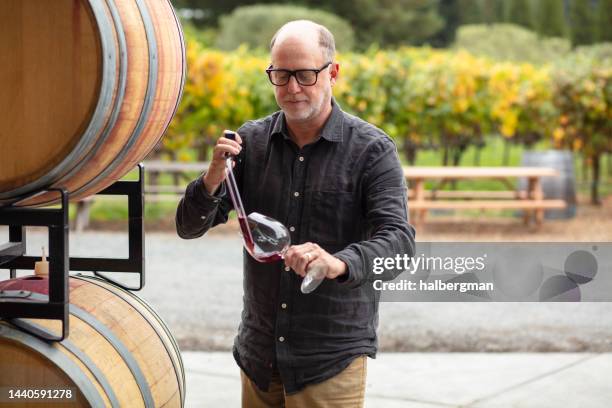 winemaker using pipette to transfer wine into glass - sonoma county stock pictures, royalty-free photos & images