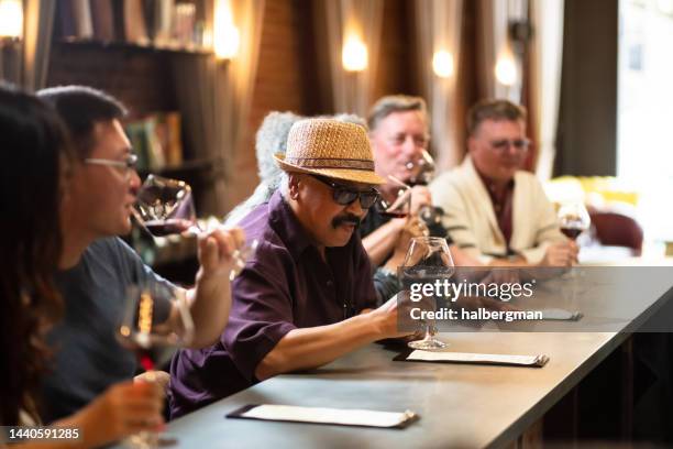 persone sedute al bar nella degustazione di vini - wine bar foto e immagini stock