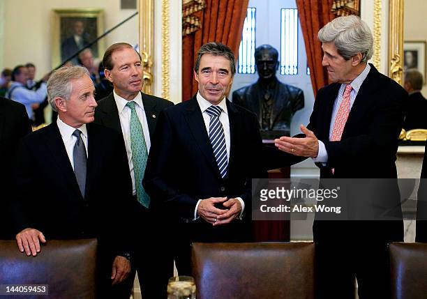 Secretary General Anders Fogh Rasmussen speaks to the media as U.S. Sen. John Kerry , Sen. Bob Corker , and Sen. Tom Udall look on prior to a meeting...