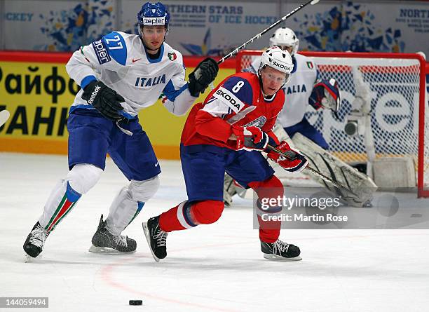 Mads Hansen of Norway and Thomas Larkin of Italy battle for the puck during the IIHF World Championship group S match between Norway and Italy at...
