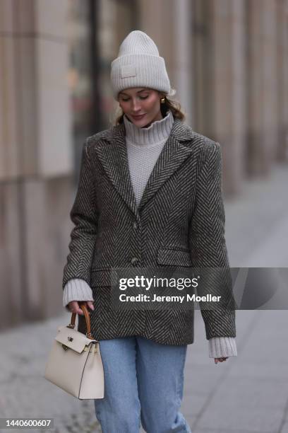 Mandy Bork wearing Agolde blue jeans, Viky Rader Studio beige knit turtleneck sweater, Nakd checked tweed blazer, Hermes beige leather Kelly bag,...