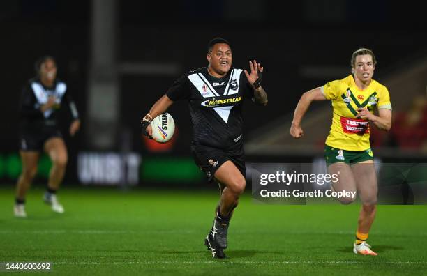 Mele Hufanga of New Zealand breaks past Emma Tonegato of Australia during the Women's Rugby League World Cup Group B match between Australia Women...