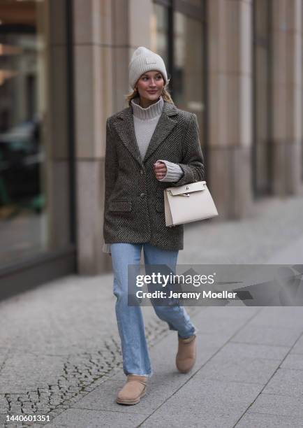 Mandy Bork wearing Agolde blue jeans, Viky Rader Studio beige knit turtleneck sweater, Nakd checked tweed blazer, Hermes beige leather Kelly bag, Ugg...