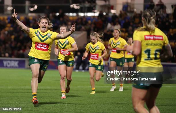 Caitlan Johnston of Australia celebrates towards Julia Robinson after they score their team's second try during the Women's Rugby League World Cup...