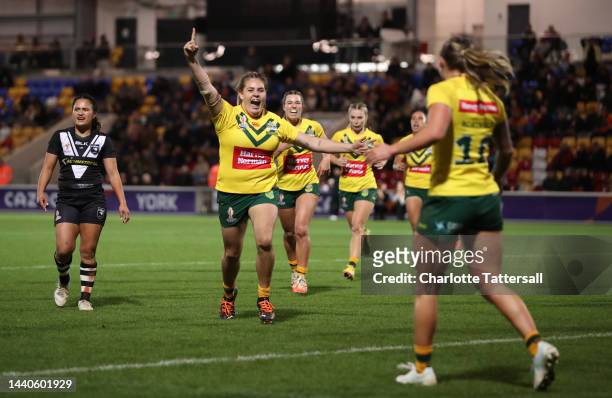 Caitlan Johnston of Australia celebrates towards teammate Julia Robinson after they score their team's second try during the Women's Rugby League...
