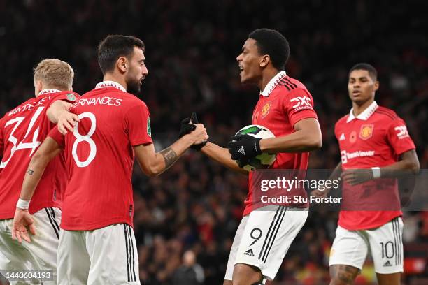 Anthony Martial of Manchester United celebrates with teammate Bruno Fernandes after scoring their team's first goal during the Carabao Cup Third...